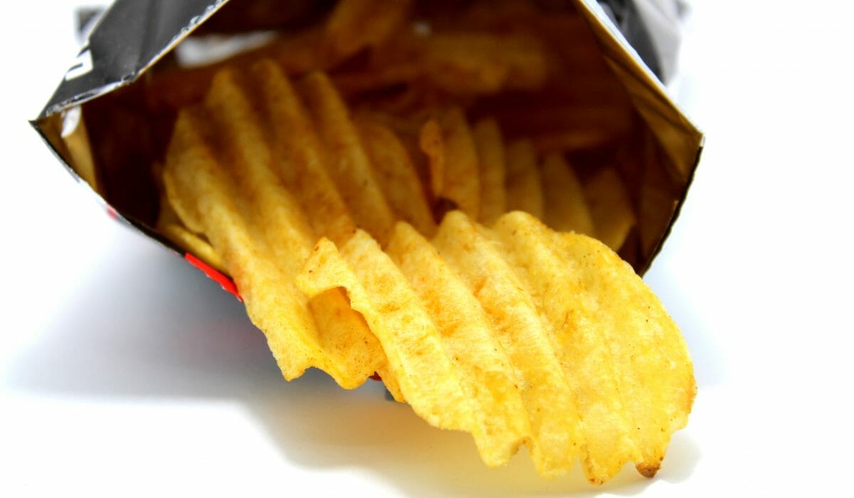 Snack potato chips heaps on a white background Eating A Low Fat Diet: Here are 10 Foods to Minimize or Avoid